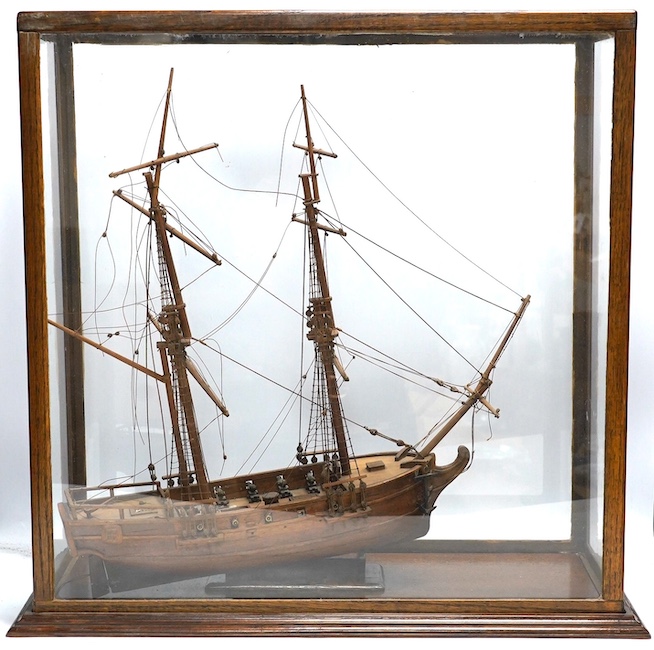 A glazed oak cased model of a ship, case 58cm tall. Condition - fair to good